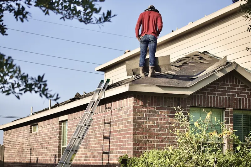 Professional roofer working on a residential roof in Fintches Corners